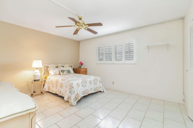 tiled bedroom with a closet and ceiling fan