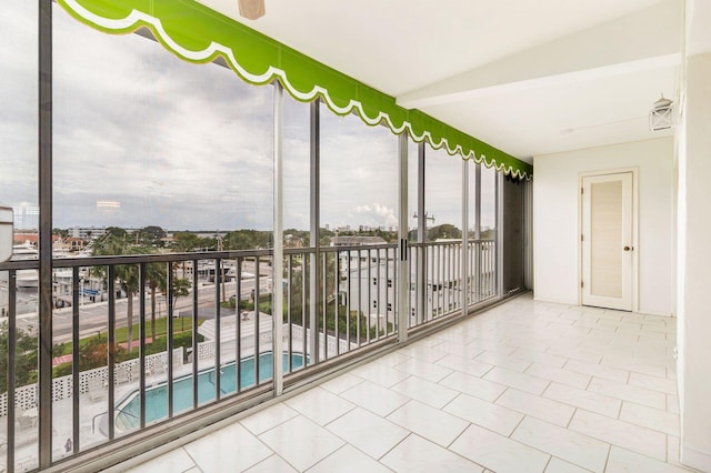 unfurnished sunroom featuring vaulted ceiling