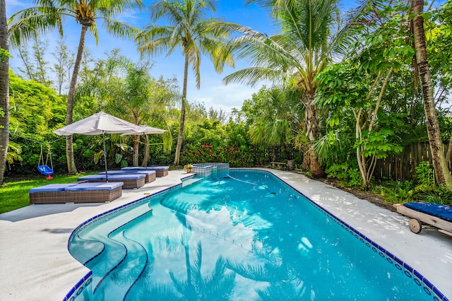 view of pool featuring an in ground hot tub and a patio