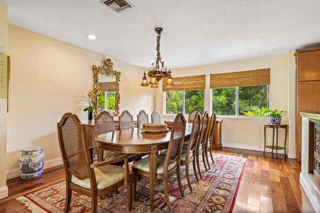 dining area featuring a chandelier and wood-type flooring