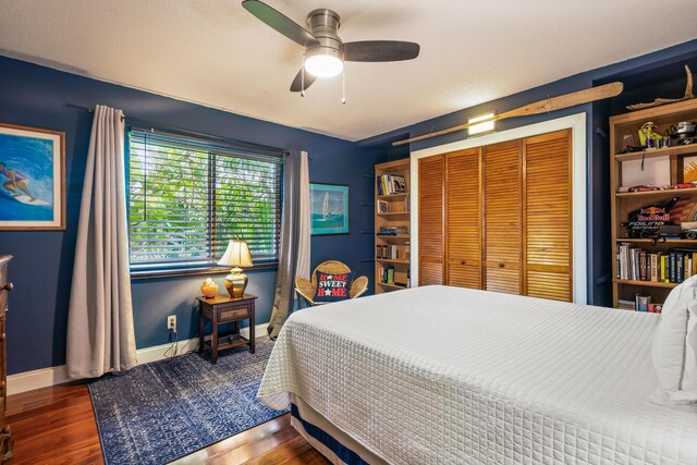 bedroom with ceiling fan, a closet, and dark hardwood / wood-style floors