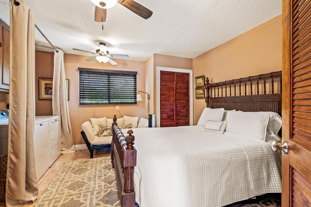 tiled bedroom with a textured ceiling, a closet, ceiling fan, and washing machine and clothes dryer