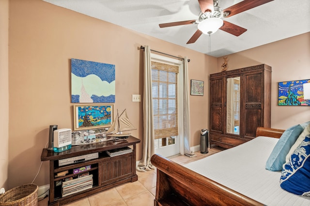 tiled bedroom featuring ceiling fan