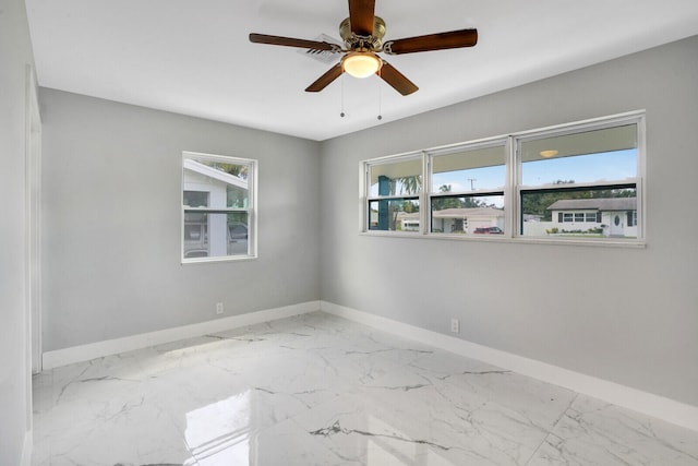 tiled empty room with ceiling fan