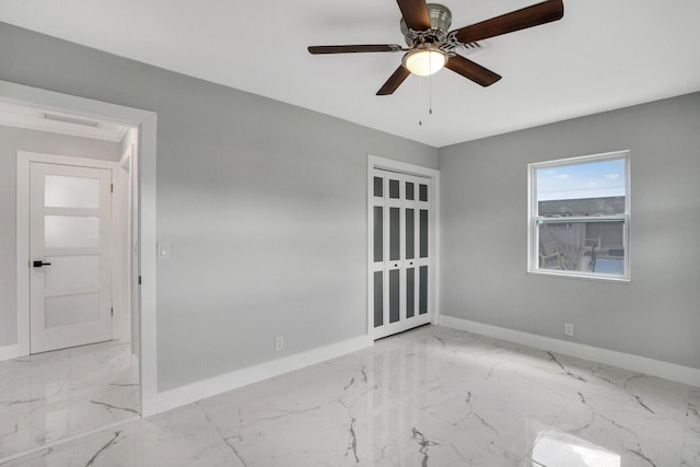 spare room featuring ceiling fan and light tile patterned flooring