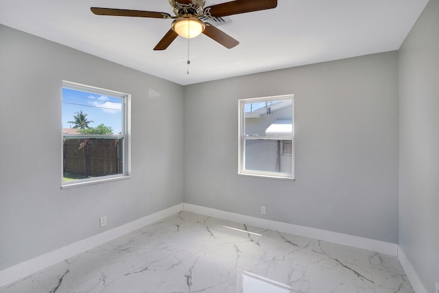 unfurnished room featuring ceiling fan and a healthy amount of sunlight