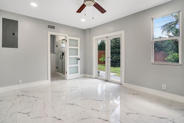 empty room with ceiling fan, built in features, french doors, and electric panel