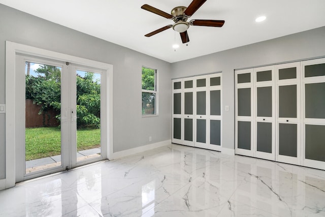 unfurnished room with ceiling fan, french doors, and light tile patterned floors