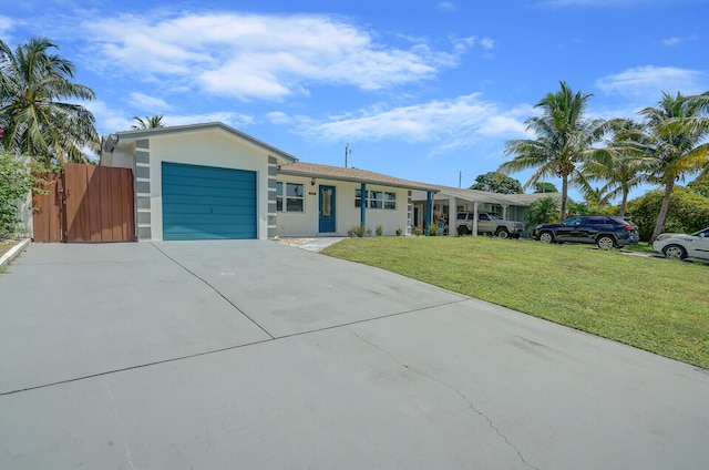 single story home featuring a garage and a front lawn