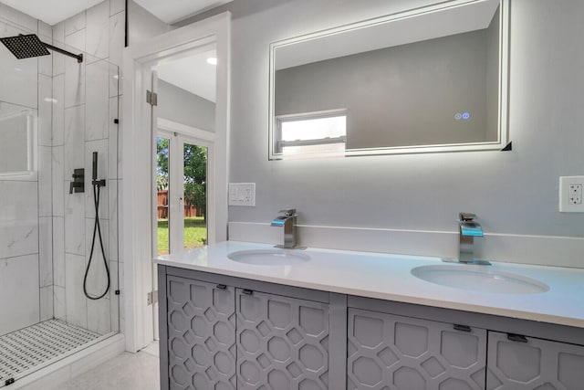 bathroom with a tile shower and vanity