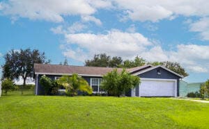 ranch-style home with a garage and a front yard