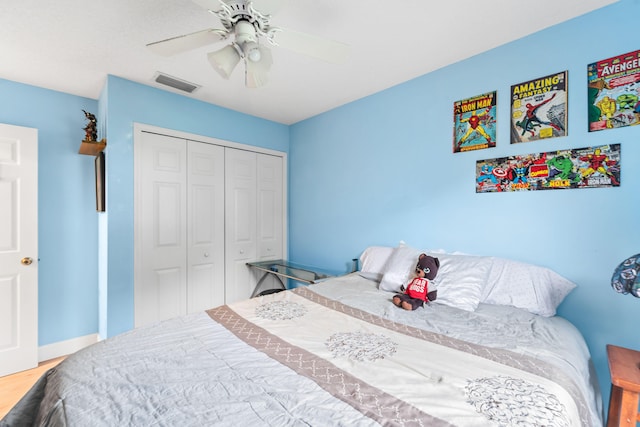 bedroom with a closet, ceiling fan, and hardwood / wood-style floors