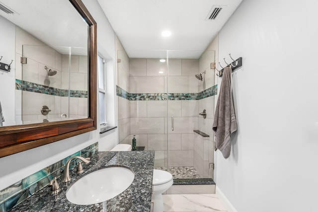 bathroom featuring vanity, an enclosed shower, and toilet