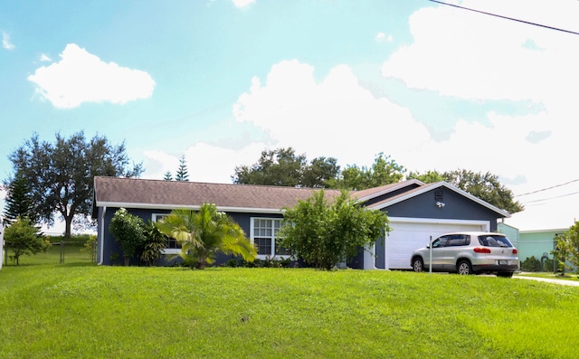 ranch-style home with a front lawn and a garage