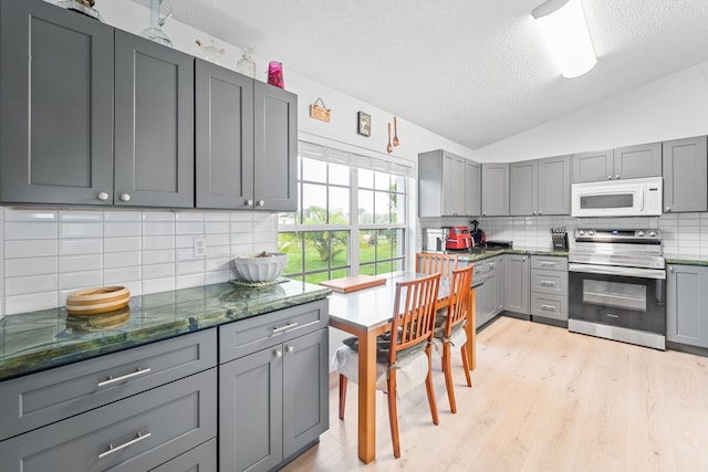 kitchen with stainless steel range with electric stovetop, gray cabinets, and decorative backsplash