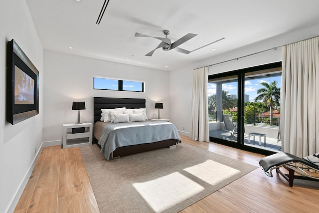 bedroom featuring access to outside, light hardwood / wood-style floors, multiple windows, and ceiling fan