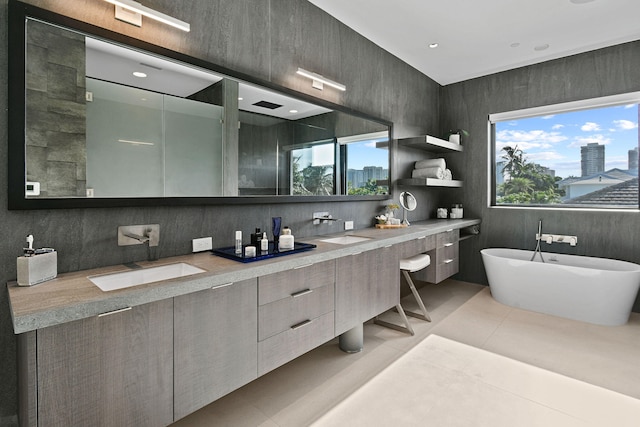 bathroom with independent shower and bath, vanity, plenty of natural light, and tile patterned flooring