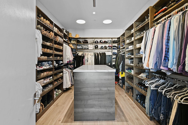 spacious closet with light hardwood / wood-style floors