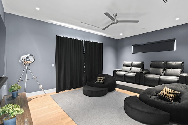 home theater featuring hardwood / wood-style floors and ceiling fan