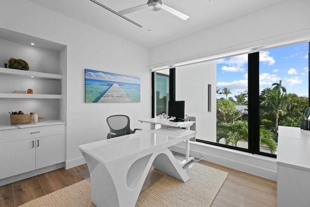 home office featuring ceiling fan, light hardwood / wood-style flooring, and plenty of natural light