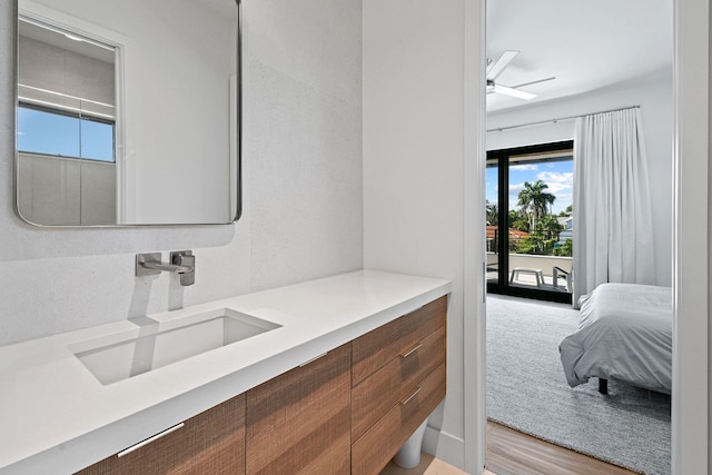 bathroom featuring ceiling fan, vanity, and wood-type flooring