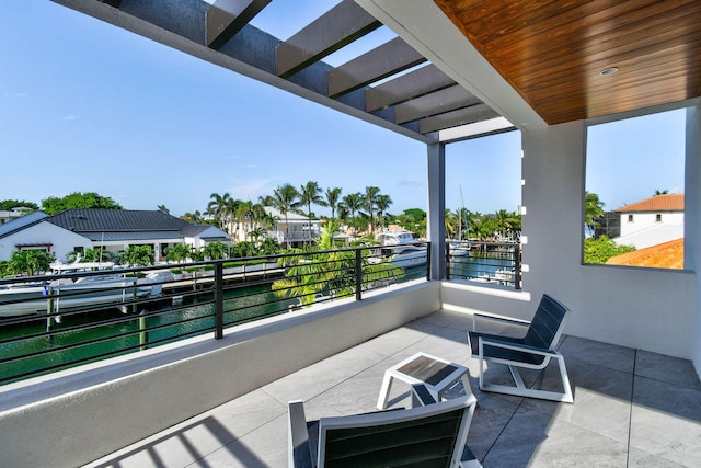 view of patio / terrace featuring a balcony and a water view