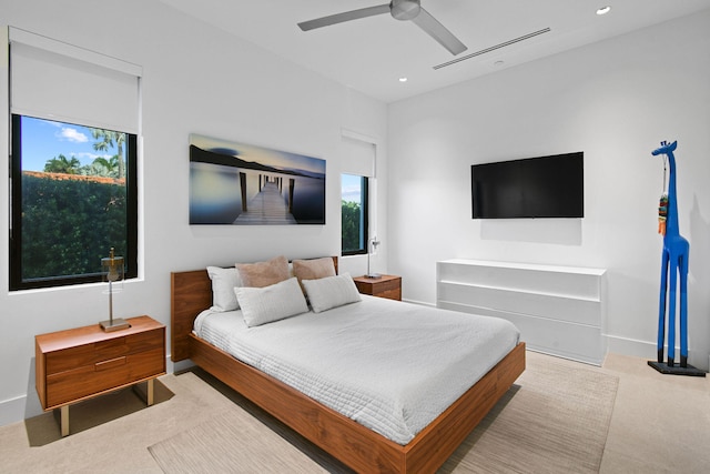 bedroom with light colored carpet and ceiling fan