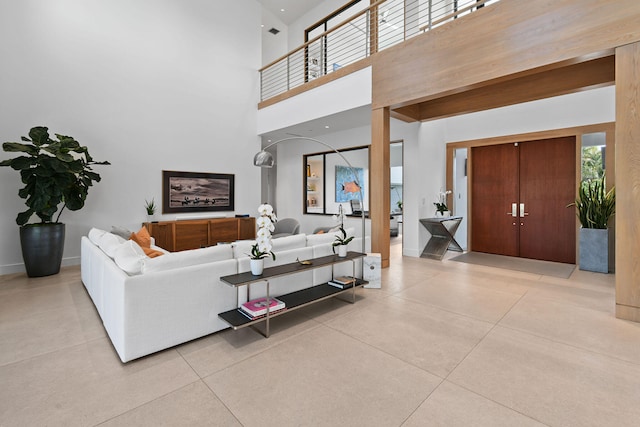 living room featuring a high ceiling and beam ceiling