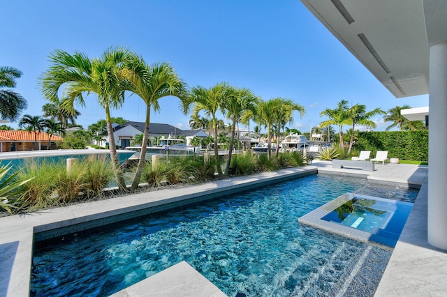 view of pool with an in ground hot tub and a patio area