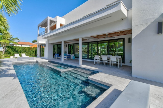 view of swimming pool featuring an in ground hot tub, ceiling fan, and a patio area