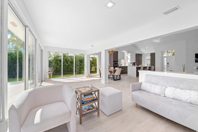 living room featuring light hardwood / wood-style flooring and lofted ceiling