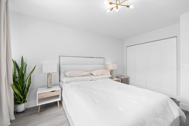 bedroom with light wood-type flooring and a closet