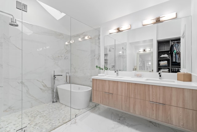 bathroom with lofted ceiling with skylight, vanity, tile patterned floors, tile walls, and plus walk in shower