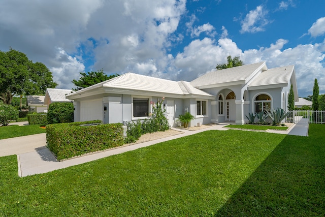 ranch-style home with a front yard and a garage