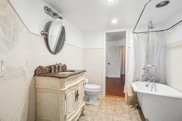 bathroom with curtained shower, tile patterned flooring, vanity, tile walls, and a freestanding bath