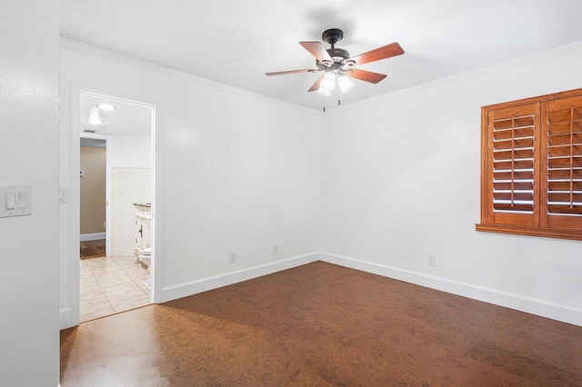 empty room with ornamental molding, ceiling fan, and baseboards