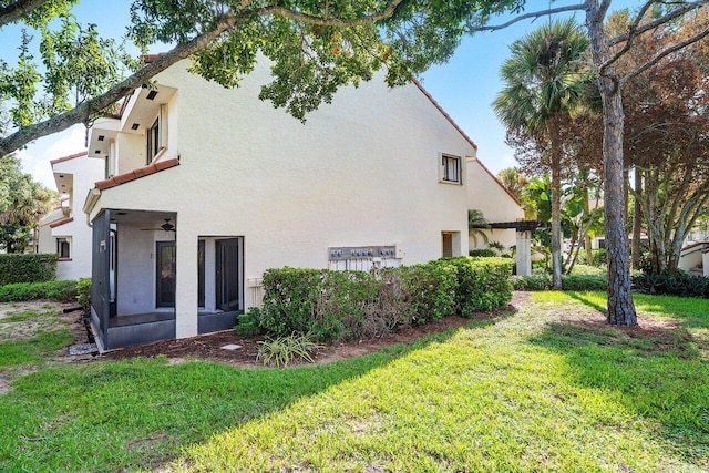 view of home's exterior featuring a yard and stucco siding