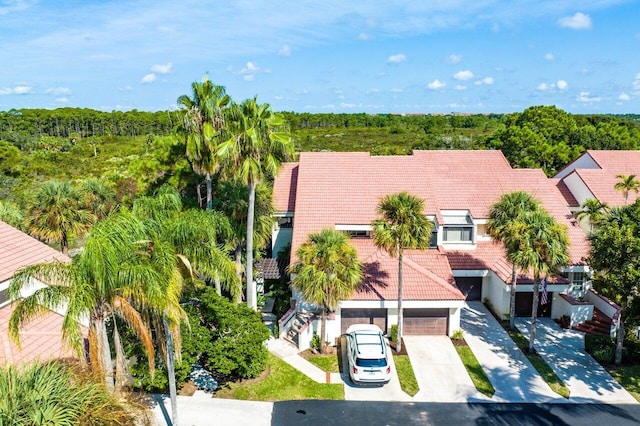 birds eye view of property featuring a view of trees