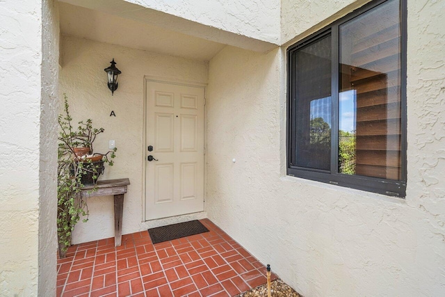 property entrance with stucco siding