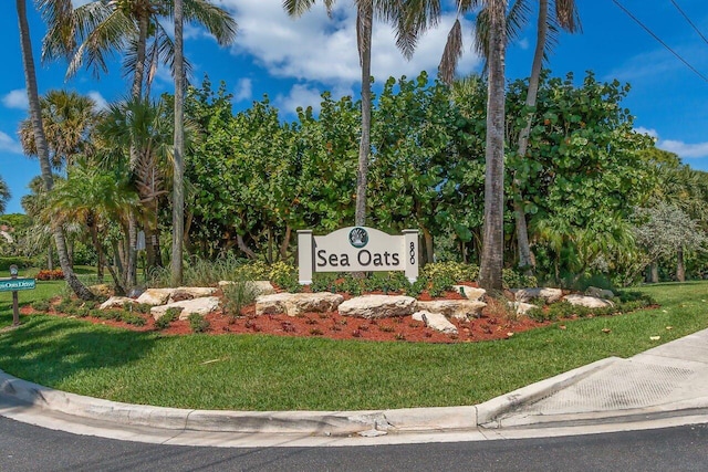 community / neighborhood sign with a lawn