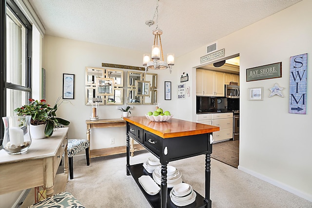 interior space featuring light carpet, baseboards, visible vents, an inviting chandelier, and a textured ceiling