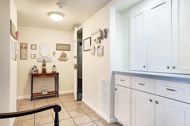 hallway featuring light tile patterned floors