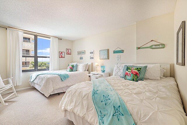 carpeted bedroom featuring a textured ceiling