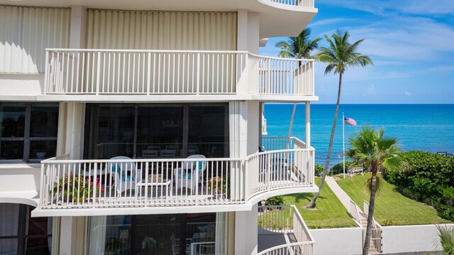 exterior space featuring a balcony and a water view