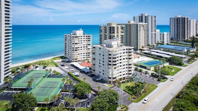 bird's eye view with a view of the beach, a water view, and a city view