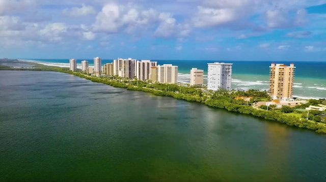 birds eye view of property with a view of city and a water view