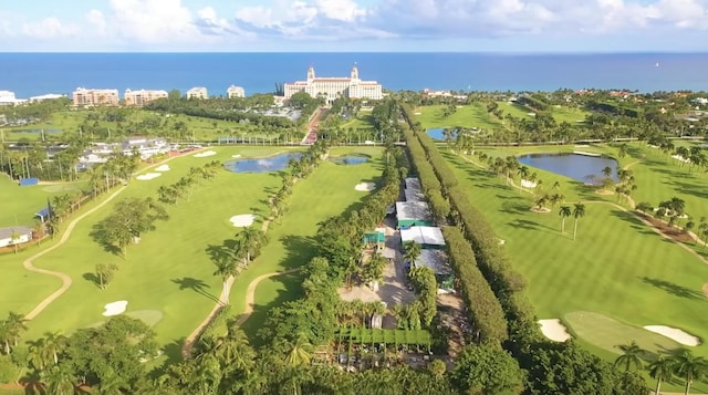 drone / aerial view with a water view and view of golf course