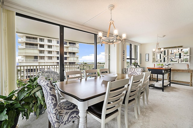 dining area featuring floor to ceiling windows, light carpet, a notable chandelier, and a textured ceiling