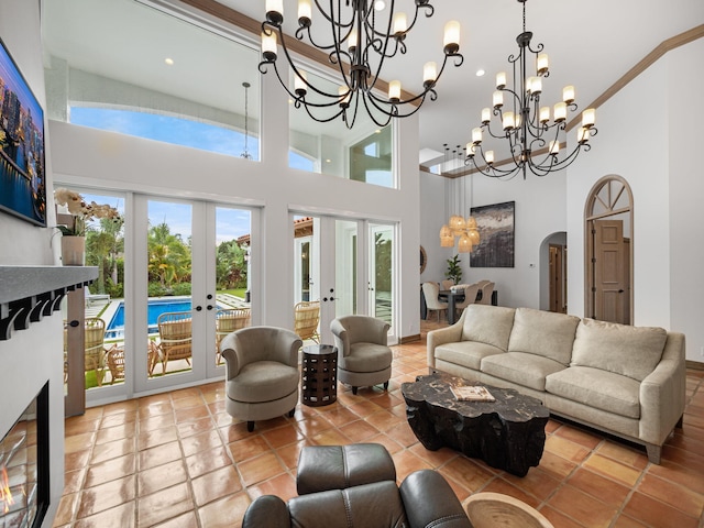 living room with light tile patterned floors, a wealth of natural light, french doors, and a chandelier