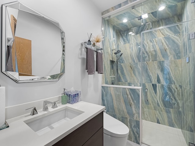 bathroom featuring toilet, walk in shower, and vanity